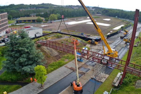 View of the dismantling of Darby House footbridge in Telford. Bridge intact with cranes on the road preparing to start the demolition.